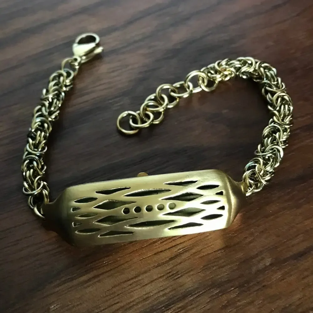 Brushed gold tone bracelet w/ a compartment for a fitbit device